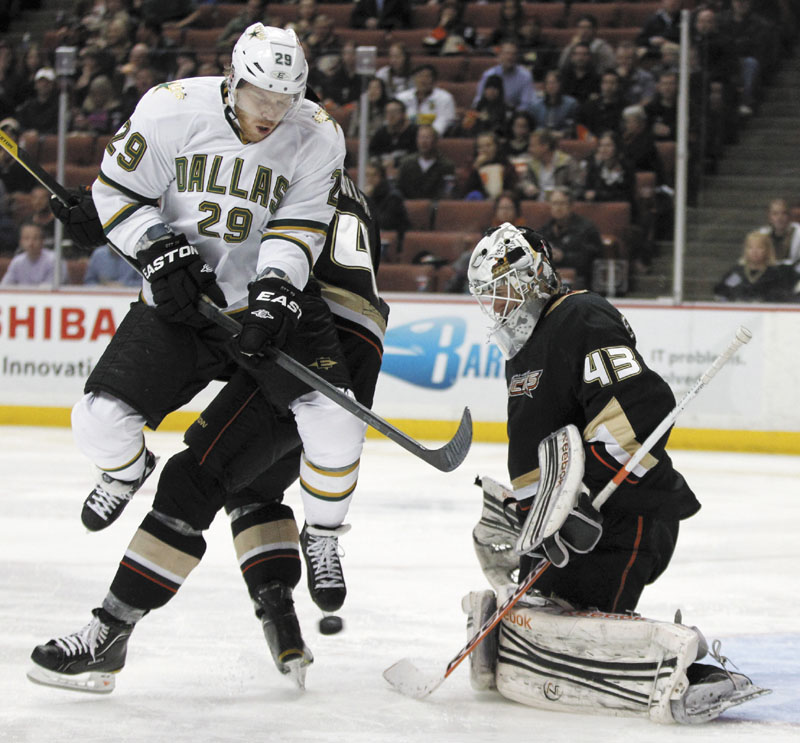 NOT SO FAST: Dallas Stars center Steve Ott, left, jumps out of the way of the puck as Anaheim Ducks goalie Jeff Deslauriers looks on during a game recently. Despite the benefits it would have for teams like the Stars, the NHL players’ association has issues with the proposal.