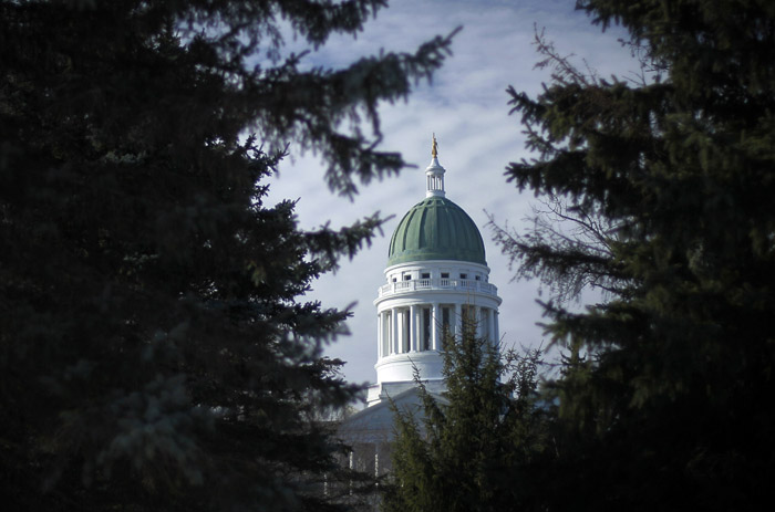The Maine State House is framed by spruce trees in Capitol Park in Augusta. The House and Senate opening bells ring at 10 a.m. on Wednesday.
