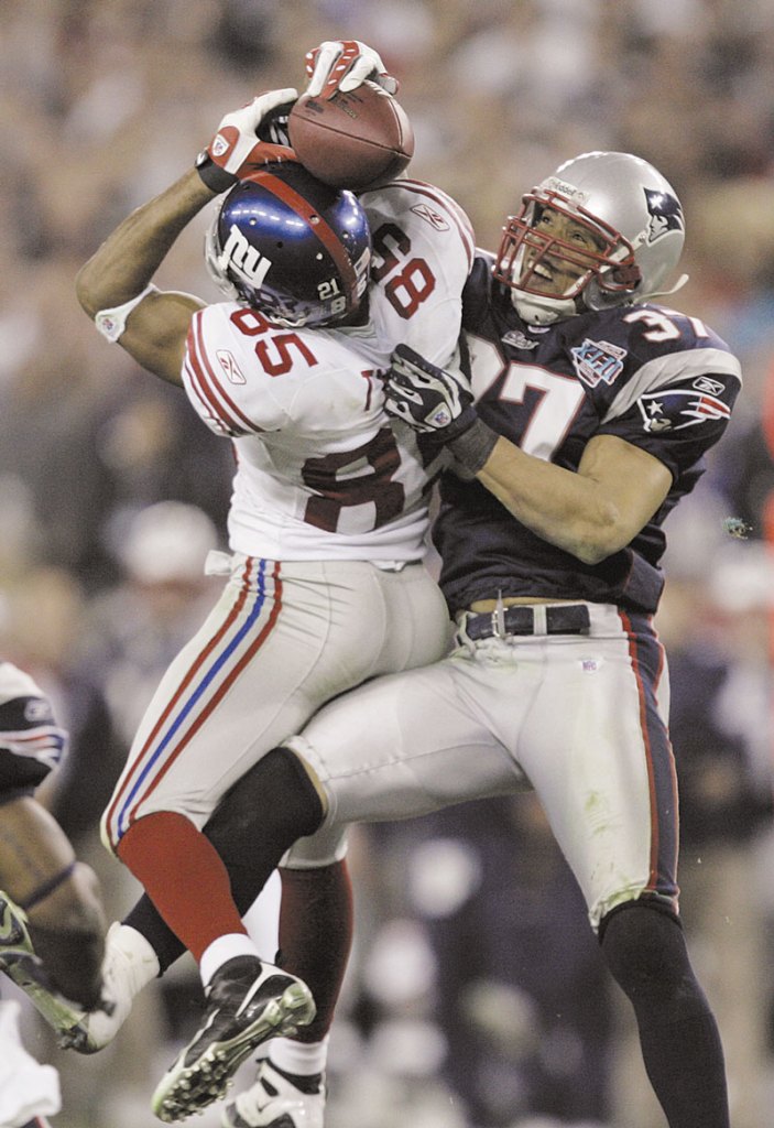 MIRACLE: New York Giants receiver David Tyree, left, catches a 32-yard pass in the clutches of New England Patriots safety Rodney Harrison during the fourth quarter of the Super Bowl XLII. That catch, which led to the game-winning touchdown, is the defining moment of Tyree’s career.
