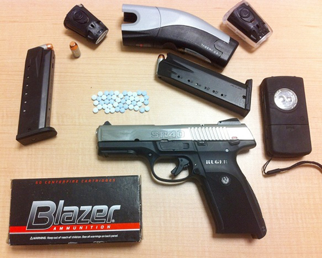 Police say items seized in the raid included this .40 caliber pistol.