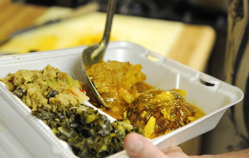 A to-go box is filled with pork roast, stuffing and wilted kale on Wednesday as the Winthrop Hot Meal Kitchen resumed serving daily mid-day meals at St. Francis Xavier Church Hall.