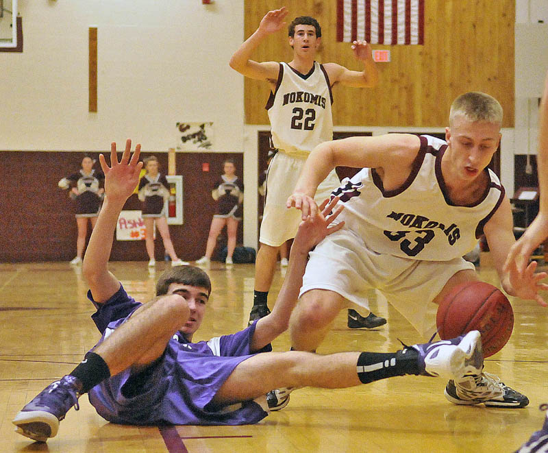 Photo by Michael G. Seamans Game action from Eastern Class B boys playoff game at Nokomis High School in Newport Wednesday night. Nokomis defeated Waterville 50-49 in overtime..