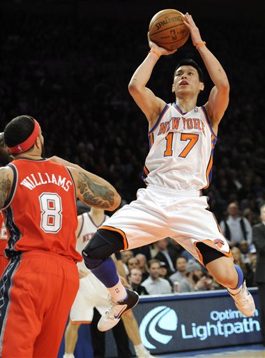 New York Knicks' Jeremy Lin (17) puts up a shot as New Jersey Nets' Deron Williams looks on during the first quarter of an NBA basketball game, Monday, Feb. 20, 2012, at Madison Square Garden in New York. (AP Photo/Bill Kostroun)