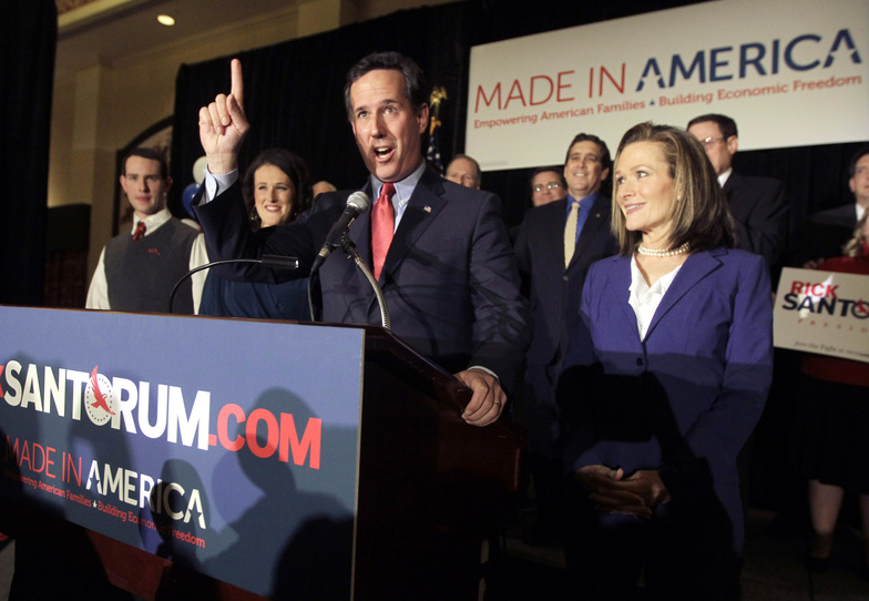 Republican presidential candidate former Pennsylvania Sen. Rick Santorum speaks to supporters Tuesday night in St. Charles, Mo. At right is his wife Karen. Among his wins Tuesday was a nonbinding primary in Missouri.