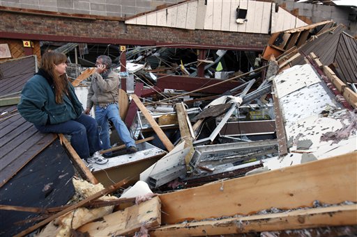 Sherry Cousins and her brother Bruce Wallace sit in the wreckage of their secondhand store in Branson, Mo. today.