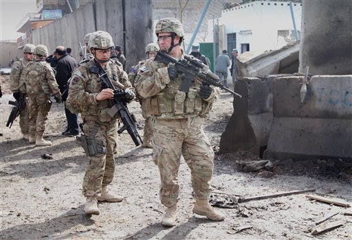 U.S. soldiers who are part of the NATO-led International Security Forces survey the scene of a suicide attack in Kandahar, south of Kabul, Afghanistan today.