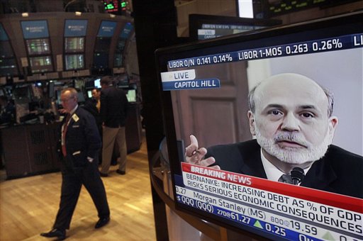 Federal Reserve Chairman Ben Bernanke's testimony before the House Budget Committee is visible on a television screen on the floor of the New York Stock Exchange today.