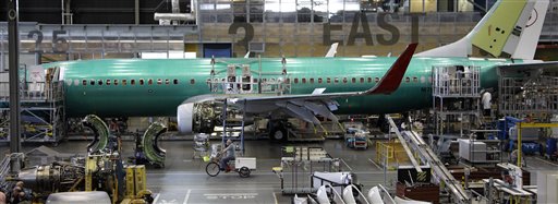 A Boeing employee rides a tricycle past a 737 airplane being assembled at the company's facility in Renton, Wash., in this June 2011 photo.