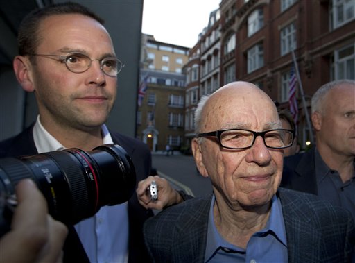 The chairman of News Corp. Rupert Murdoch, right, and his son James in a July 2011 photo. James Murdoch is stepping down as executive chairman of the company's U.K. newspaper arm.