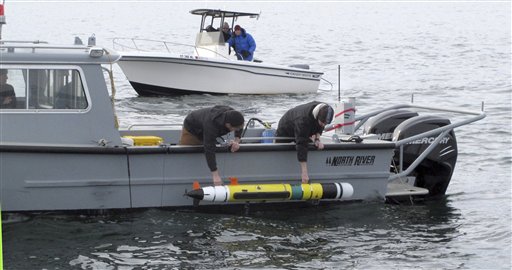 Researchers lower an underwater robot into Block Island Sound off the Westerly, R.I., coast on Wednesday to explore a shipwreck thought to be the USS Revenge.