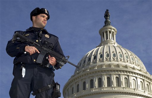 Capitol Police Officer Angel Morales stands guard on the west side of the Capitol in Washington today following the arrest of a 29-year-old terror suspect in an FBI sting operation.