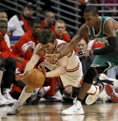 Chicago Bulls small forward Kyle Korver, left, goes after a loose ball against Boston Celtics point guard Rajon Rondo during the second half Thursday in Chicago. The Bulls won 89-80.