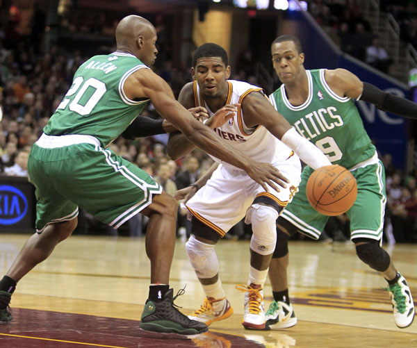 2ND HALF BEGINS: Cleveland Cavaliers point guard Kyrie Irving, center, drives between Boston Celtics guards Ray Allen left, and Rajon Rondo in the second quarter Tuesday night in Cleveland. Boston won 86-83.