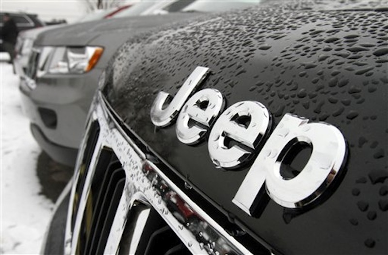 The Chrysler Jeep logo is displayed on 2012 Jeep Grand Cherokee on the lot of Willie Racine's Jeep in South Burlington, Vt. Chrysler rode higher sales of Jeeps and other revamped vehicles to its first annual net income since 1997. (AP Photo/Toby Talbot)