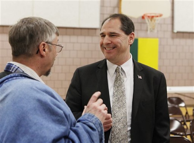 Senatorial hopeful Scott D'Amboise, speaks with an unidentified supporter during the Kennebec County Super Caucus in Augusta, Maine on Saturday, Feb. 4, 2012. (AP Photo/Joel Page)