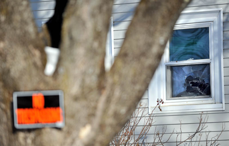 ACCESSING THE DAMAGE: A broken window in the background is one of several windows broken Friday night at Justin DePietro’s residence at 29 Violette Ave.