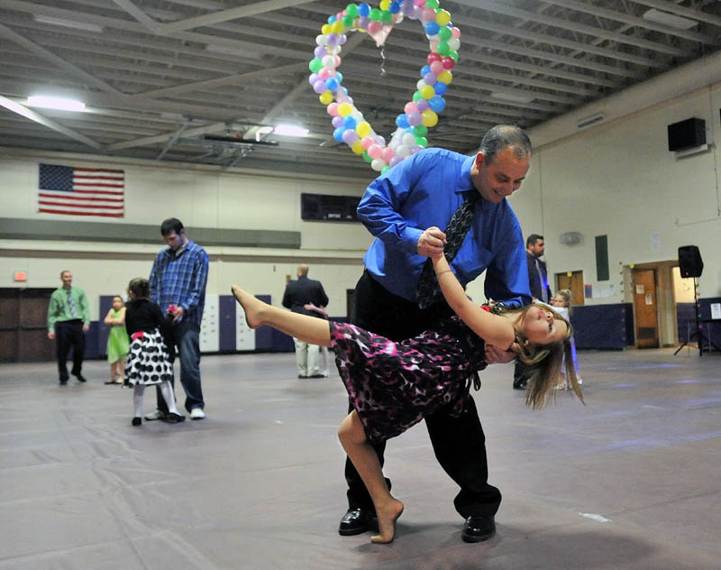 Rick Michaud dances with his daughter Emma, 6, at the 18th Annual Father/Daughter Dance at Waterville Junior High School Friday night.