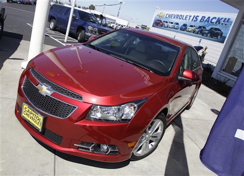 In this Aug. 30, 2011 photo, a 2011 Chevrolet Cruze is featured at a car dealership in San Jose, Calif. General Motors Co. said Thursday, Feb. 16, 2012, it made more money in 2011 than any year in its history. (AP Photo/Paul Sakuma)