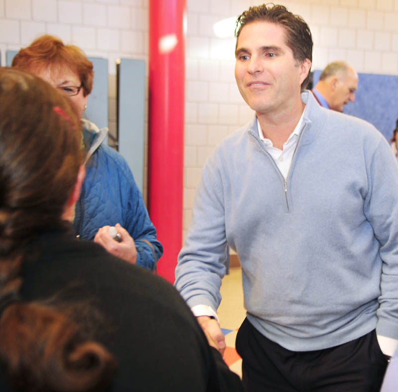 Tagg Romney greets voters before the Kennebec County Super Caucus at Farrington School in Augusta on Saturday.