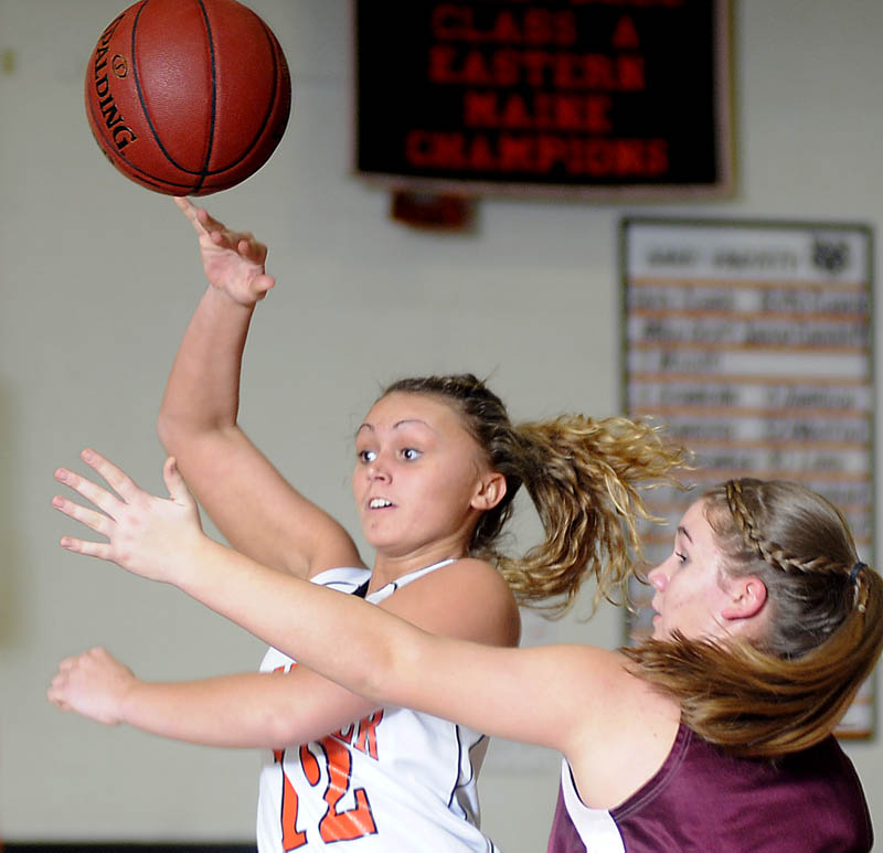 FOR YOU: Gardiner Area High School’s Taylor Banister, left, passes over Foxcroft Academy’s MacKenzie Coiley during an Eastern Maine Class B preliminary game Tuesday in Gardiner.