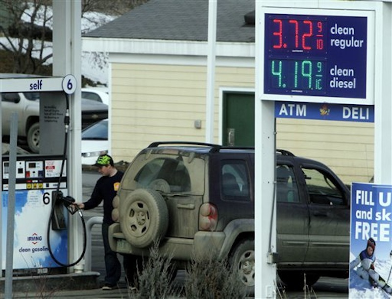 In this Feb. 16 photo, a customer fills up at an Irving Oil gas station, in Berlin, Vt. Gasoline prices have never been higher at this time of year. (AP Photo/Toby Talbot)