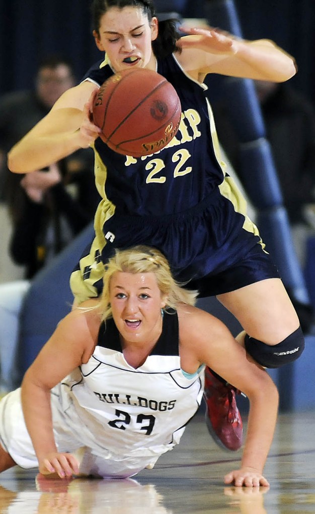 Hall-Dale High School's Carylanne Wolfington, bottom, comes up after scrambling for the ball with R.W. Traip Academy's Selene Lorrey during a tournament basketball match up Thursday in Augusta.