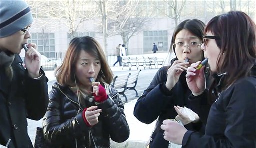 In this recent image taken from video, students try free samples of AeroShot on the campus of Northeastern University in Boston. Harvard University engineering professor David Edwards created AeroShot.