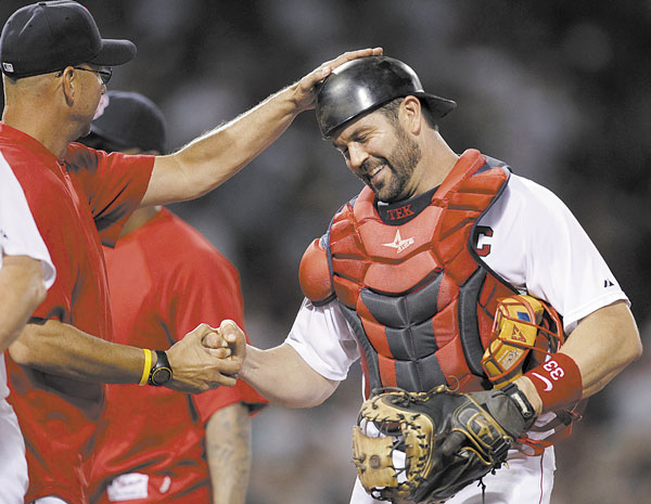CALLING IT A CAREER: For 15 years, Jason Varitek, right, was the voice in the Boston pitching staff’s ear, and the target behind the plate, giving the Red Sox their hard-nosed, gritty identity that they used to win two World Series titles. Now, it appears that era has come to an end.