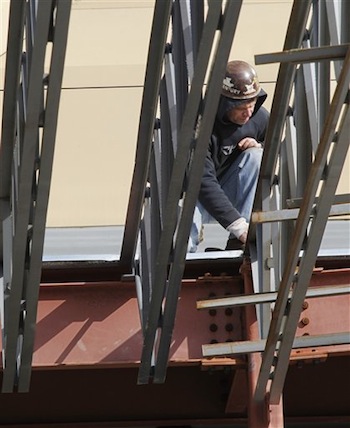 In this Feb. 1, 2012 photo, an ironworker works in the steel framework of a roof in the remodeling of a downtown hotel in Pittsburgh. (AP Photo/Keith Srakocic)