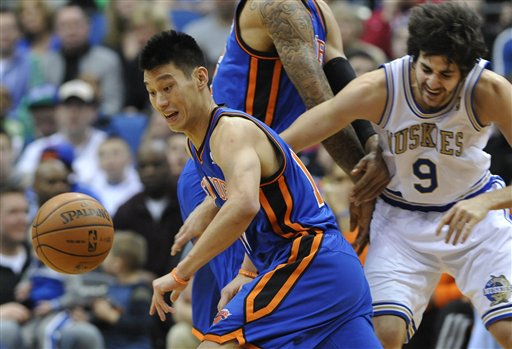 New York Knicks' Tyson Chandler, center, sets a pick on Minnesota Timberwolves' Ricky Rubio, right, of Spain, as Knicks' Jeremy Lin, left, chases the loose ball in the first half of an NBA basketball game on Saturday in Minneapolis.