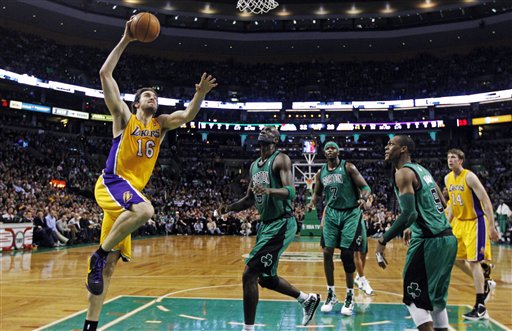 Los Angeles Lakers power forward Pau Gasol (16) drives to the basket past Boston Celtics' Kevin Garnett, center, Jermaine O'Neal (7), Rajon Rondo (9) and Lakers' Troy Murphy (14) during the first quarter of an NBA basketball game in Boston, Thursday, Feb. 9, 2012. Gasol contributed 25 points as the Lakers won 88-87 in overtime. (AP Photo/Charles Krupa)