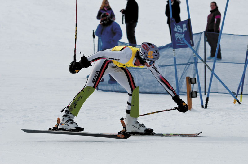 CROSSING THE LINE: Mt. Blue's Lucas Bonnevie reaches out to trip the timer at the finish line Saturday morning at Titcomb Mountain. Bonnevie won the Kennebec Valley Athletic Conference slalom title after winning the giant slalom championship Wednesday at Black Mountain.