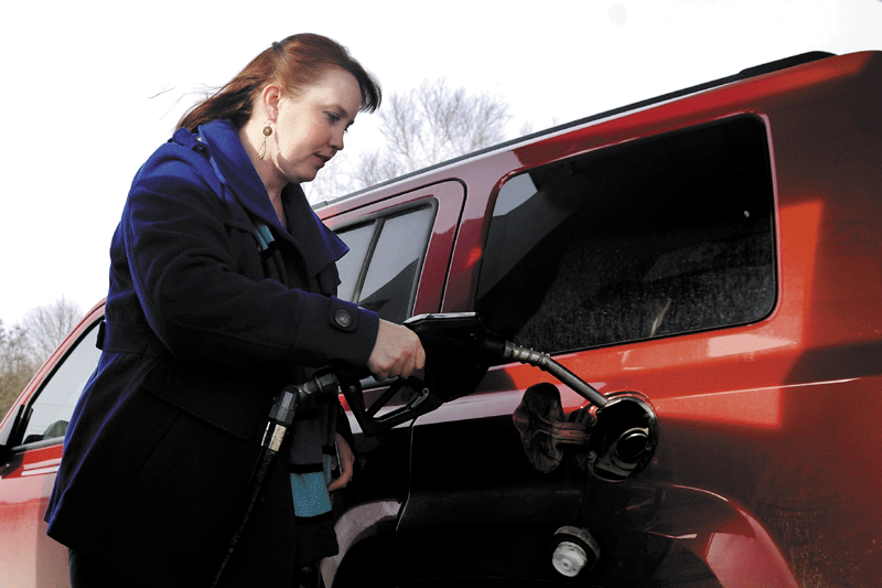 PUMPED: Carrie Parker, of Belgrade, fills up her vehicle Tuesday in Augusta. Gas prices are spiking across the country.