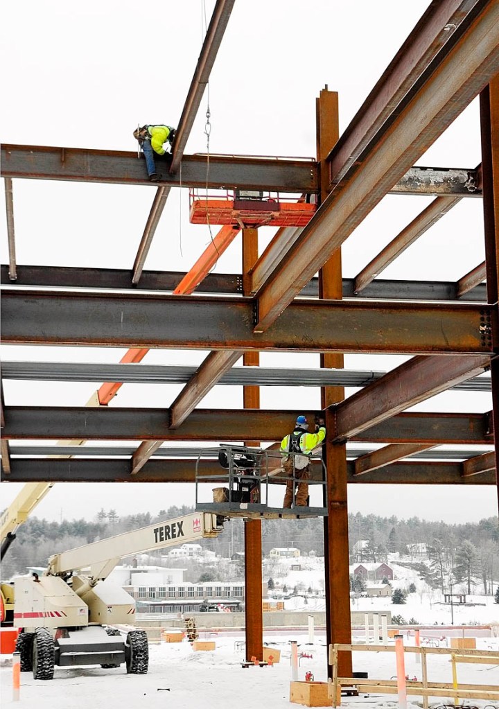 Steel workers attach beams into position Tuesday afternoon at the construction site for the new MaineGeneral hospital in North Augusta.
