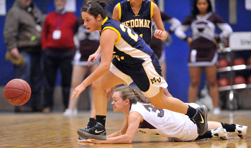 Photo by Michael G. Seamans Medomak Valley High School's Amanda Hendrickson-Belloguet, 25, chases down the ball as Nokomis High School's Taylor Shaw, 32, dives in the first half of the Eastern Class B quarterfinals game at the Bangor Auditorium Saturday. Nokomis defeated Medomak Valley 58-51.