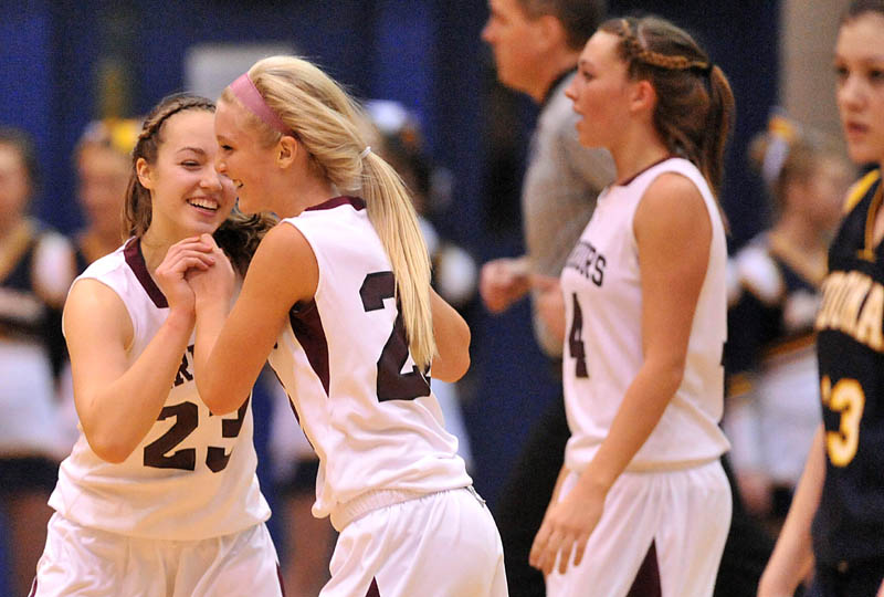 Photo by Michael G. Seamans Nokomis High School teammates Kelsie Richards, 23, left, and Lindsay Whitney, 22, center, celebrate after defeating Medomak Valley 58-51 in the Eastern Class B quarterfinals game at the Bangor Auditorium Saturday.