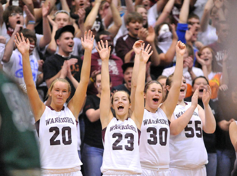 Photo by Michael G. Seamans Nokomis High School teammates from left to right Emilee Reynolds, 20, Kelsie Richards, 23, Anna Mackenzie, 30, and Traci Carson, 55, celebrate after defeating Old Town High School 52-31 of the Eastern Class B semi-finals at the Bangor Auditorium Wednesday.