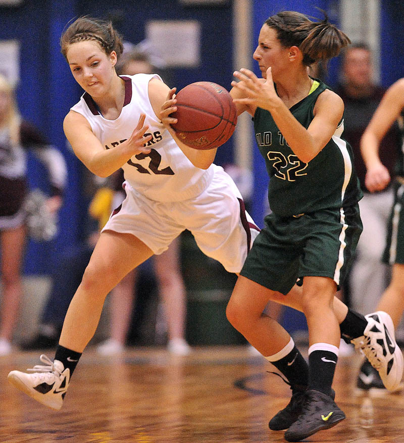 Photo by Michael G. Seamans Nokomis High School's Kylie Richards, 12, makes a steal in front of Old Town High School's Ashley Abbott, 32, in the first half of the Eastern Class B semi-finals at the Bangor Auditorium Wednesday.