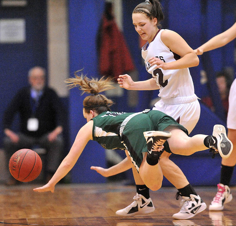 Photo by Michael G. Seamans Old Town High School guard Ashley England, 10, goes down as she is defended by Nokomis High School's Kylie Richards, 12, in the first half of the Eastern Class B semi-finals at the Bangor Auditorium Wednesday.