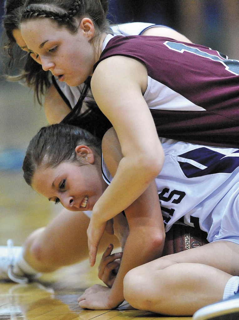 HIT THE DECK: Nokomis’ Kylie Richards, top, battles for a loose ball with Presque Isle’s Chelsea Nickerson in the Eastern B championship game Saturday at the Bangor Auditorium. Nokomis, which was aiming for its third straight regional title, lost 52-40.