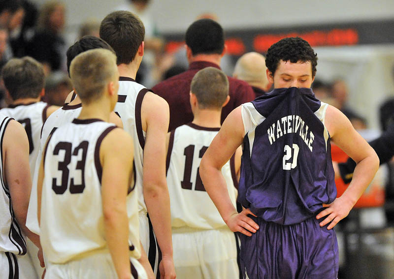 Photo by Michael G. Seamans Waterville Senior High School's Josh Gromley, 20, far right, reacts after losing to Nokomis High School 50-49 in overtime at Nokomis High School in Newport Wednesday night.