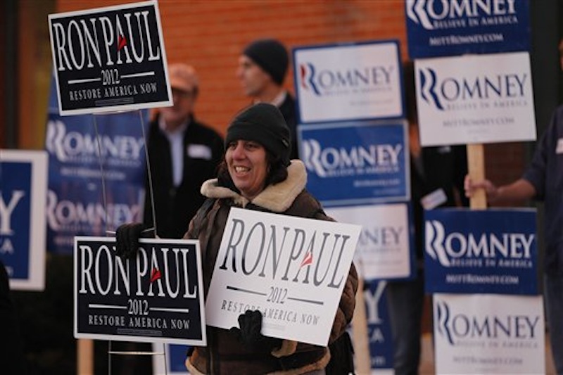 Merav Yaakov hold signs in support of Republican presidential candidate, Rep. Ron Paul, R-Texas, outside a scheduled event for Republican presidential candidate Mitt Romney. (AP Photo/Matt Rourke)