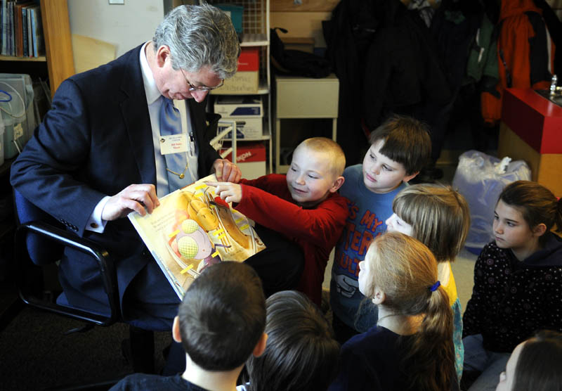 Augusta Mayor William Stokes gets some help Monday reading a book from first-grade students attending Moe Heikkila’s class at Lincoln Elementary School in Augusta. Stokes and several other prominent Augusta citizens read to the children as part of a readathon at the school.