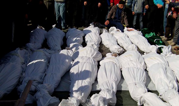 Residents attend a burial ceremony for what activists say are victims of shelling by the Syrian army, in the Khalidiya neighbourhood in Homs on Saturday.