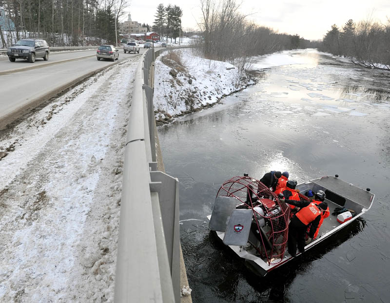 Authorities clear Messalonskee Stream of ice with an air boat near North Street bridge in Waterville Saturday morning.