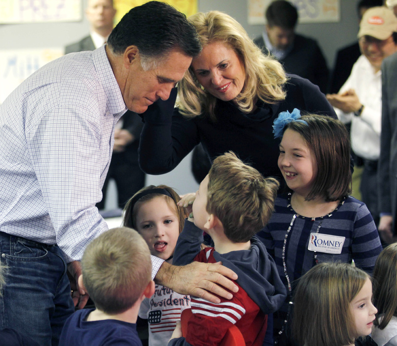 Republican presidential candidate, former Massachusetts Gov. Mitt Romney, and his wife Ann, greet children of campaign volunteers as they visit a campaign call center in Livonia, Mich., on Tuesday.