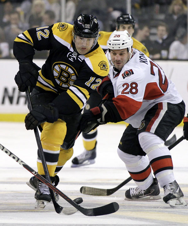 NEW ACQUISITION: Boston Bruins left wing Brian Rolston, left, controls the puck past Ottawa Senators center Zenon Konopka during the second period of their game Tuesday night in Boston. The Bruins lost 1-0.