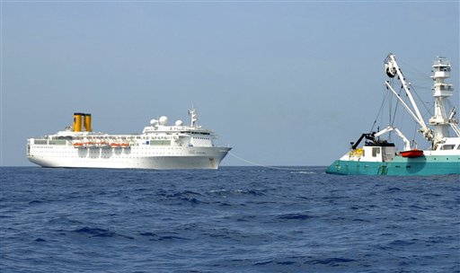In this photo taken by a member of French fishing vessel, The Talenduic, and provided by the Prefecture of the Reunion Island, shows the Italian cruise ship, The Costa Allegra, left, being towed by French fishing vessel, The Trevignon, in the Indian Ocean today.