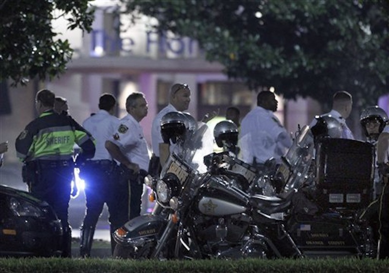Police gather outside The Florida Mall in Orlando, Fla. late Thursday, Feb. 23, 2012 after more than 100 sheriff's deputies in riot gear broke up an out-of-control crowd waiting to buy a new Nike basketball shoe at one of the stores. (AP Photo/Reinhold Matay)
