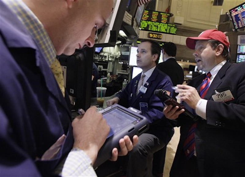 Trader Edward Schreier, right, works with specialist John Alatzas, center, on the floor of the New York Stock Exchange today.